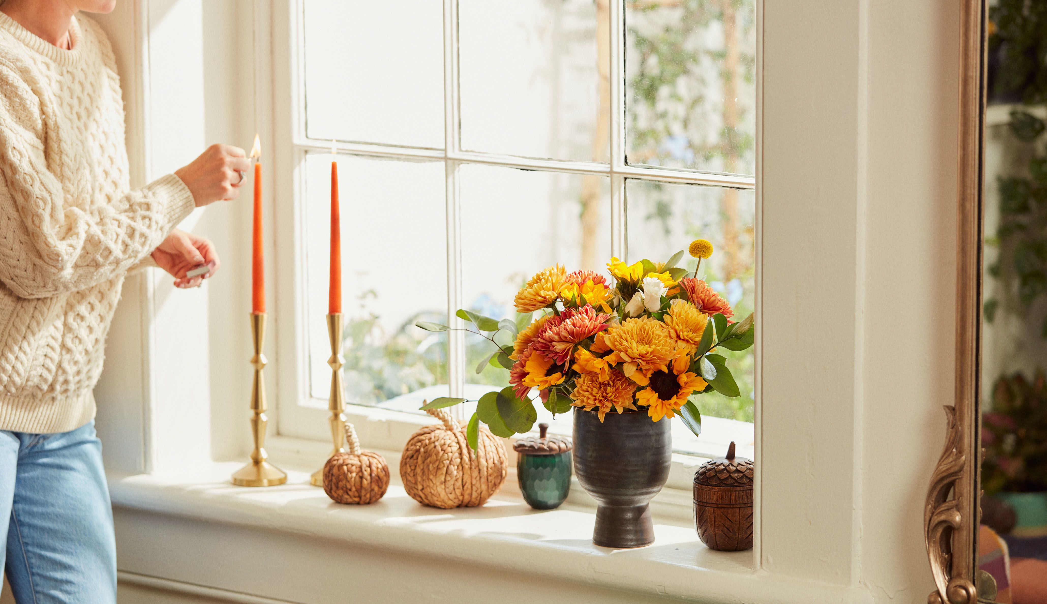 Woman setting up 2022 Thanksgiving floral decor