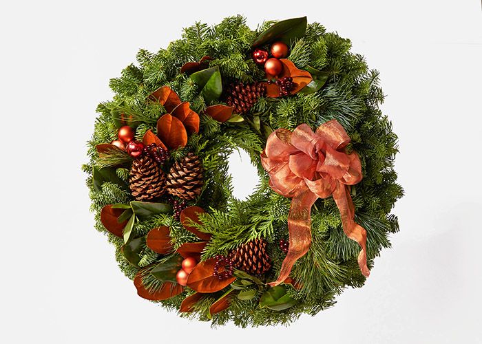 Magnolia leaves and noble fir wreath with pine and shimmery gold bow