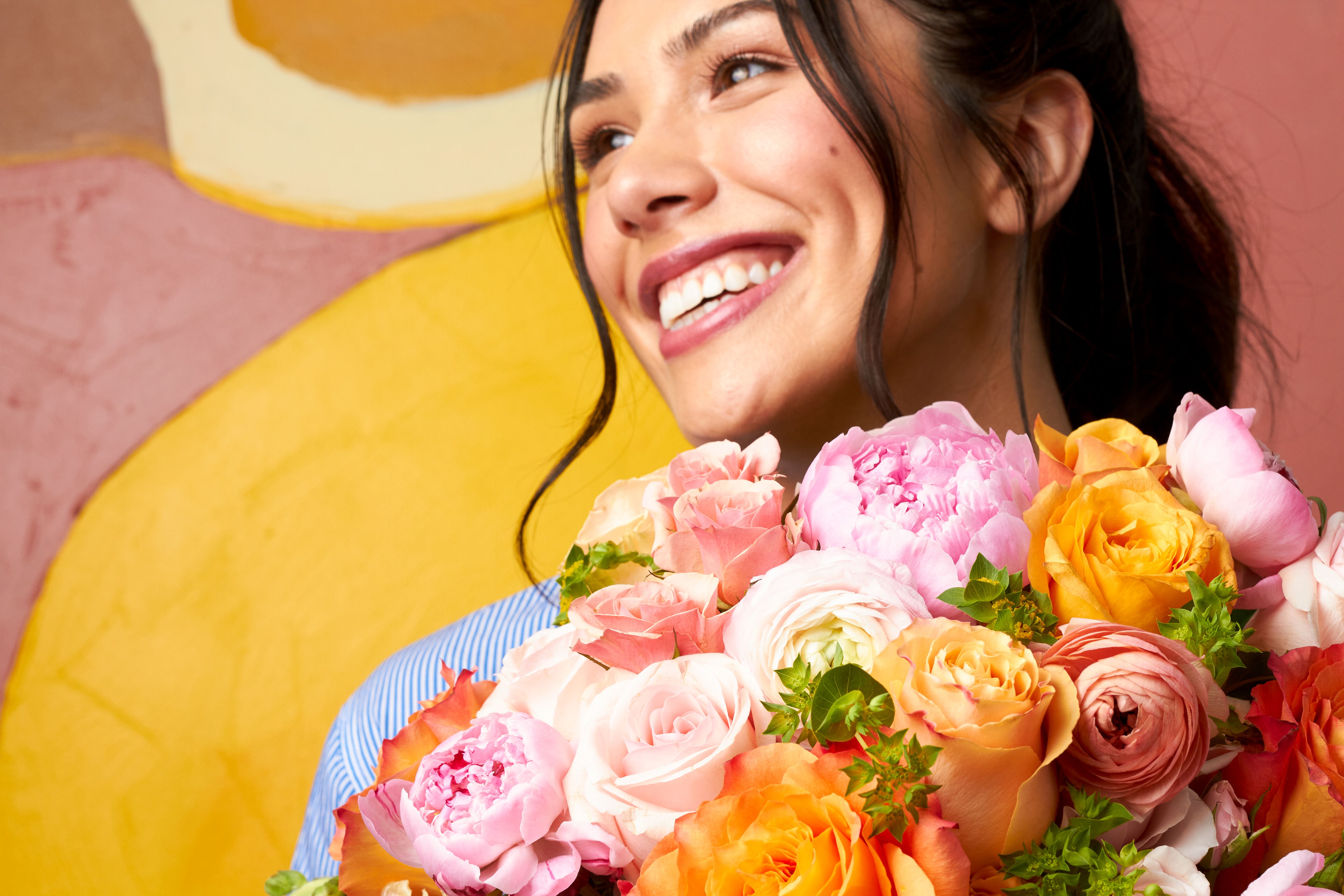 Close up of a woman holding a bouquet in preparation for Easter brunch.