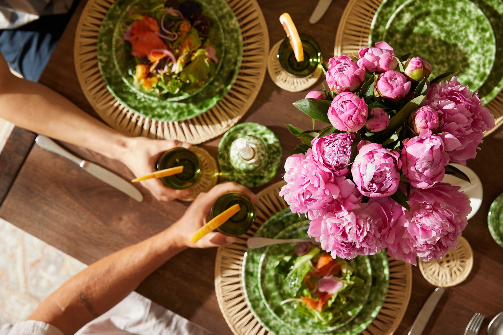 Pink peony bouquet by UrbanStems set on a dinner party table.