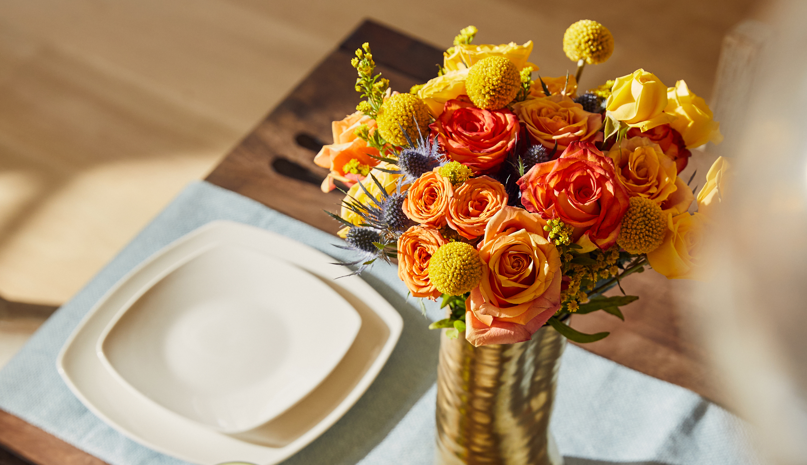 Table set with a lively summer bouquet