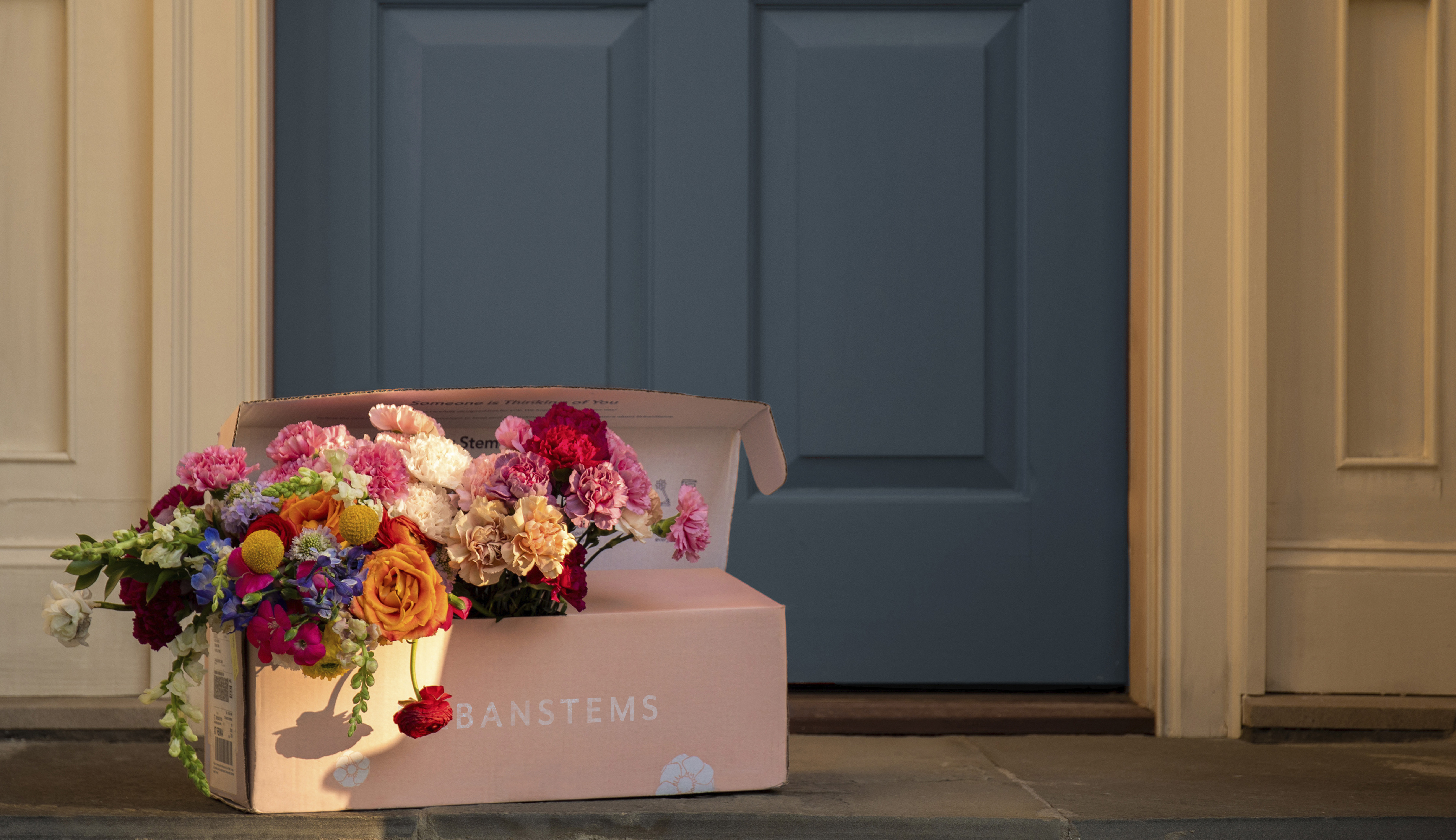 Floral bouquet in same-day deliver box on doorstep
