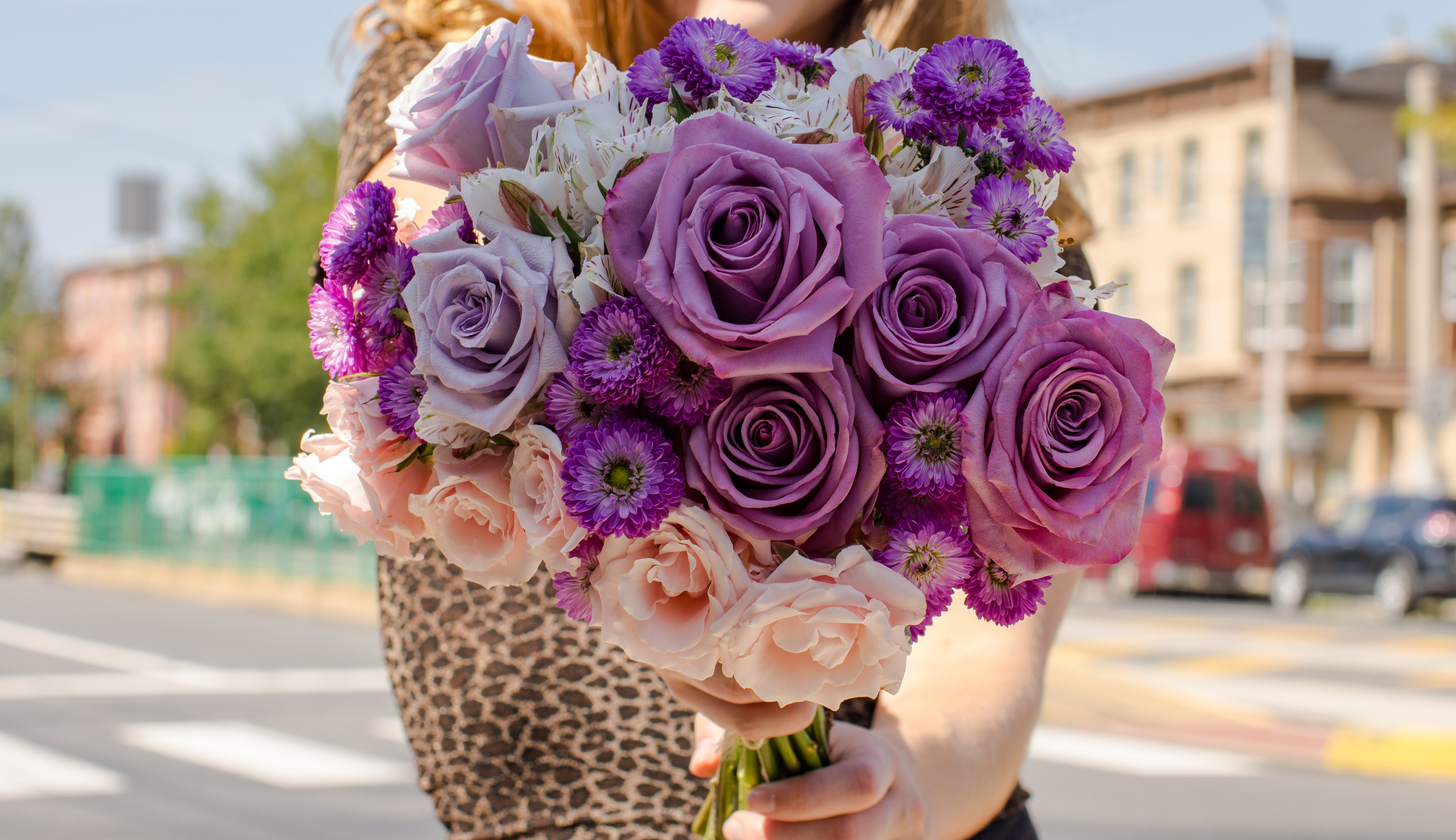 Close up of floral bouquet containing purple asters