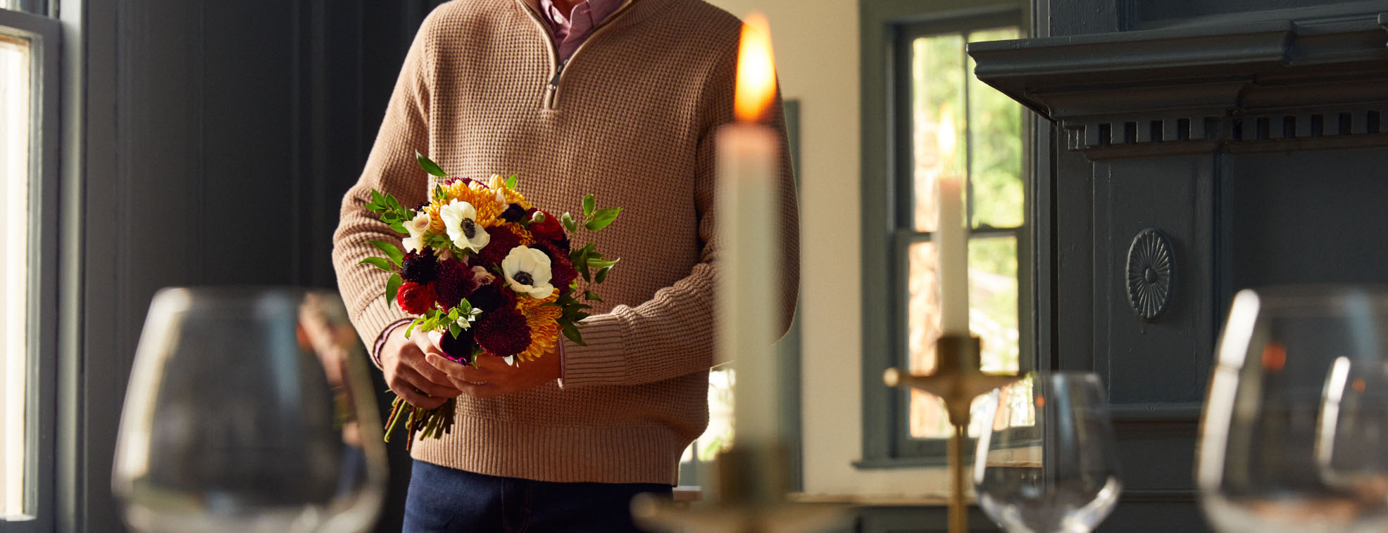 Man holding a bouquet of mum flowers for entertaining