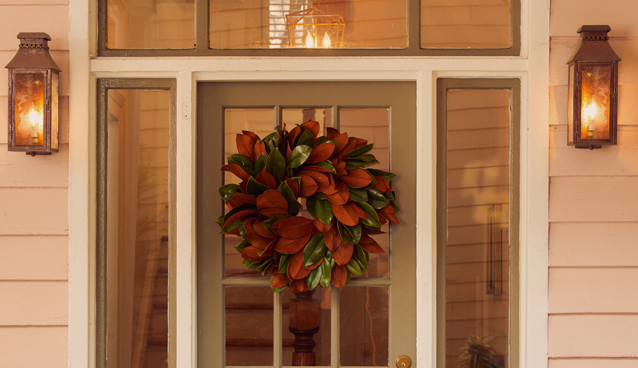 Holiday wreath with magnolia leaves on door