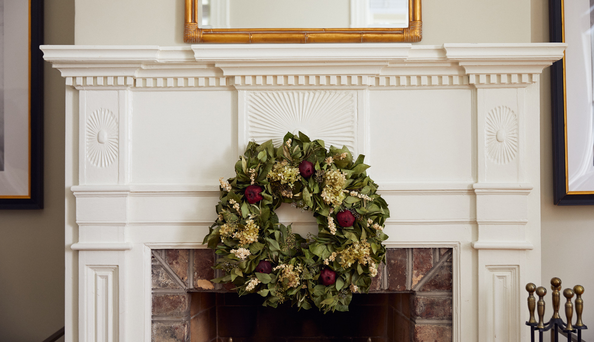 Holiday wreath hanging above a fireplace