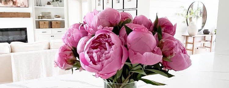 Close up of a bouquet featuring bright pink peonies