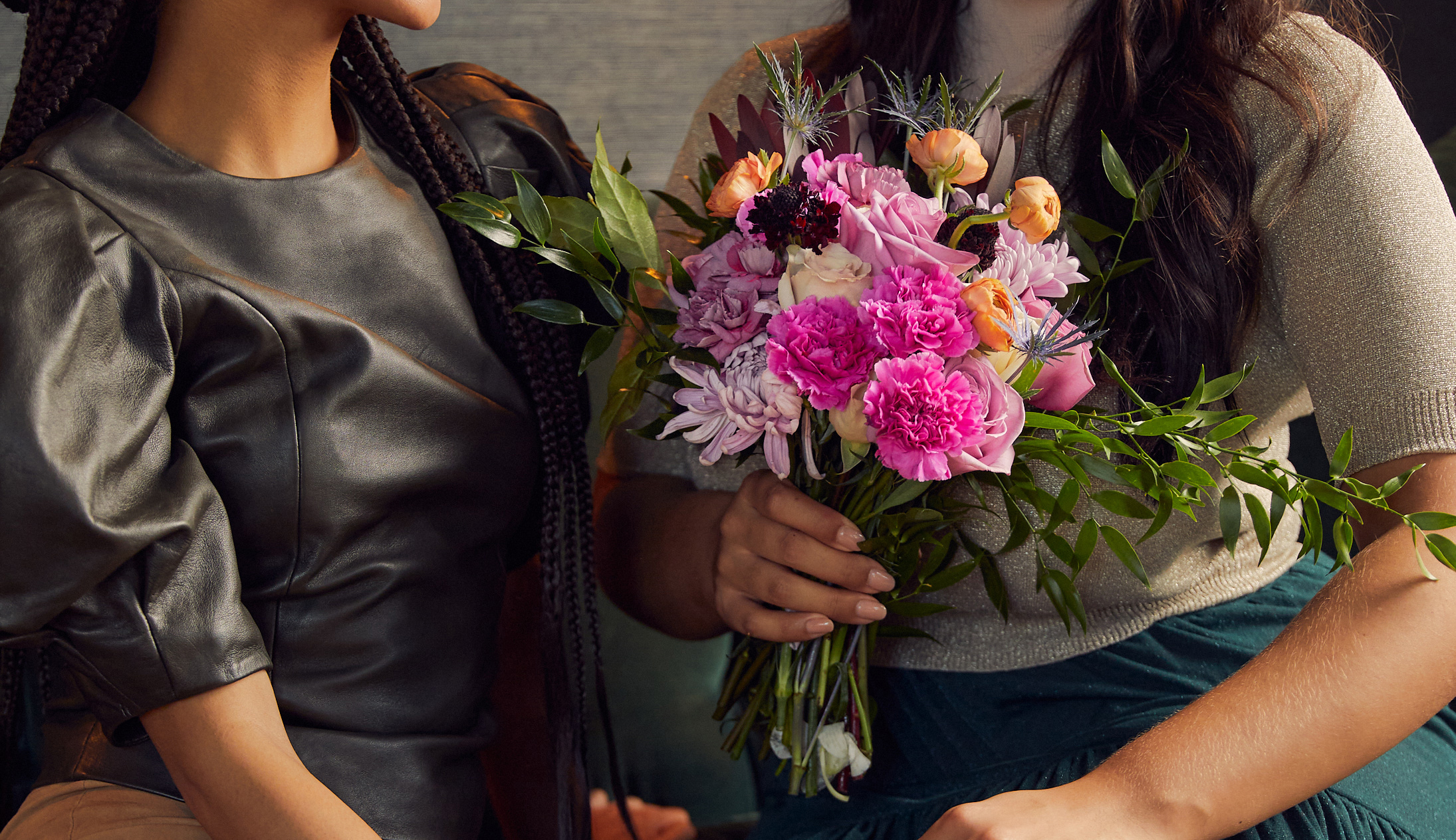 Women holding a floral bouquet as a holiday present