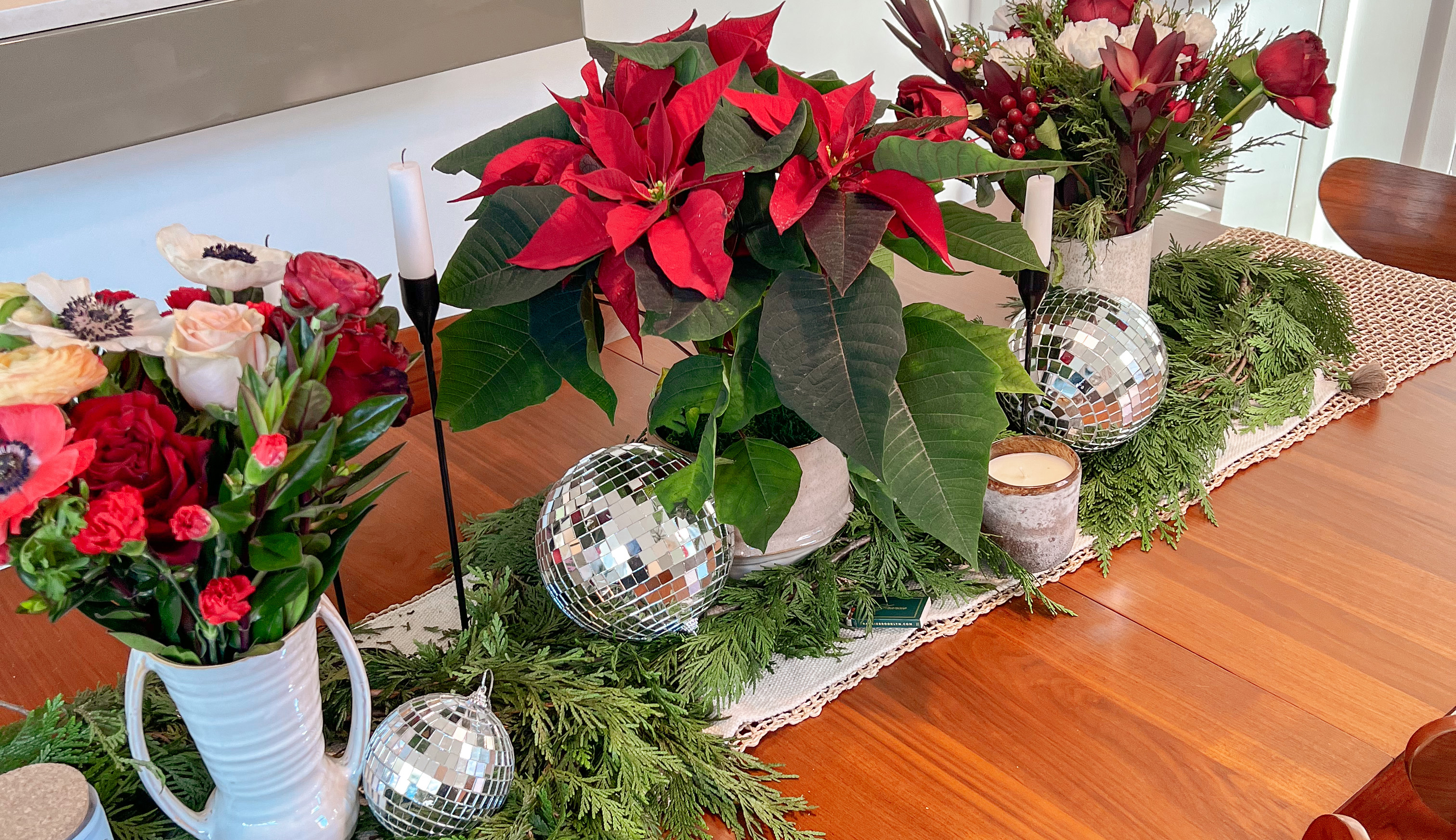 Holiday centerpiece featuring floral arrangements and poinsettia plants