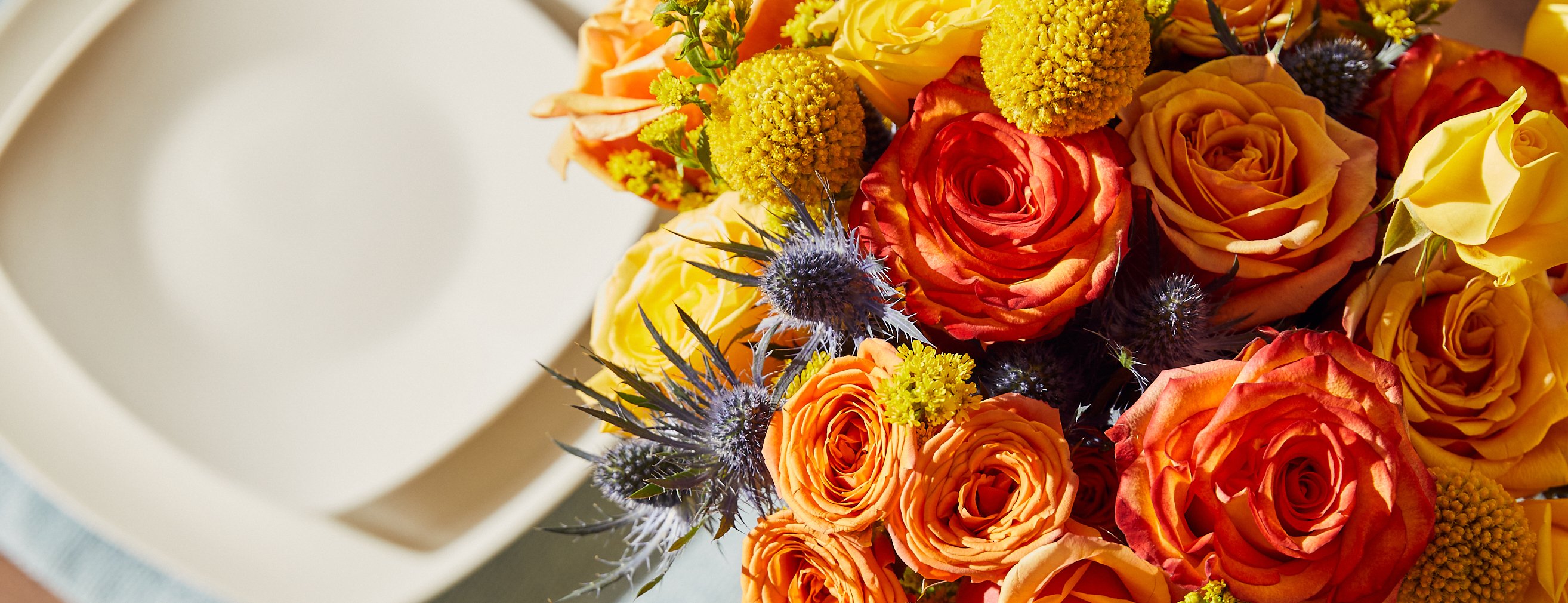 Close up of vibrant orange and blue floral bouquet