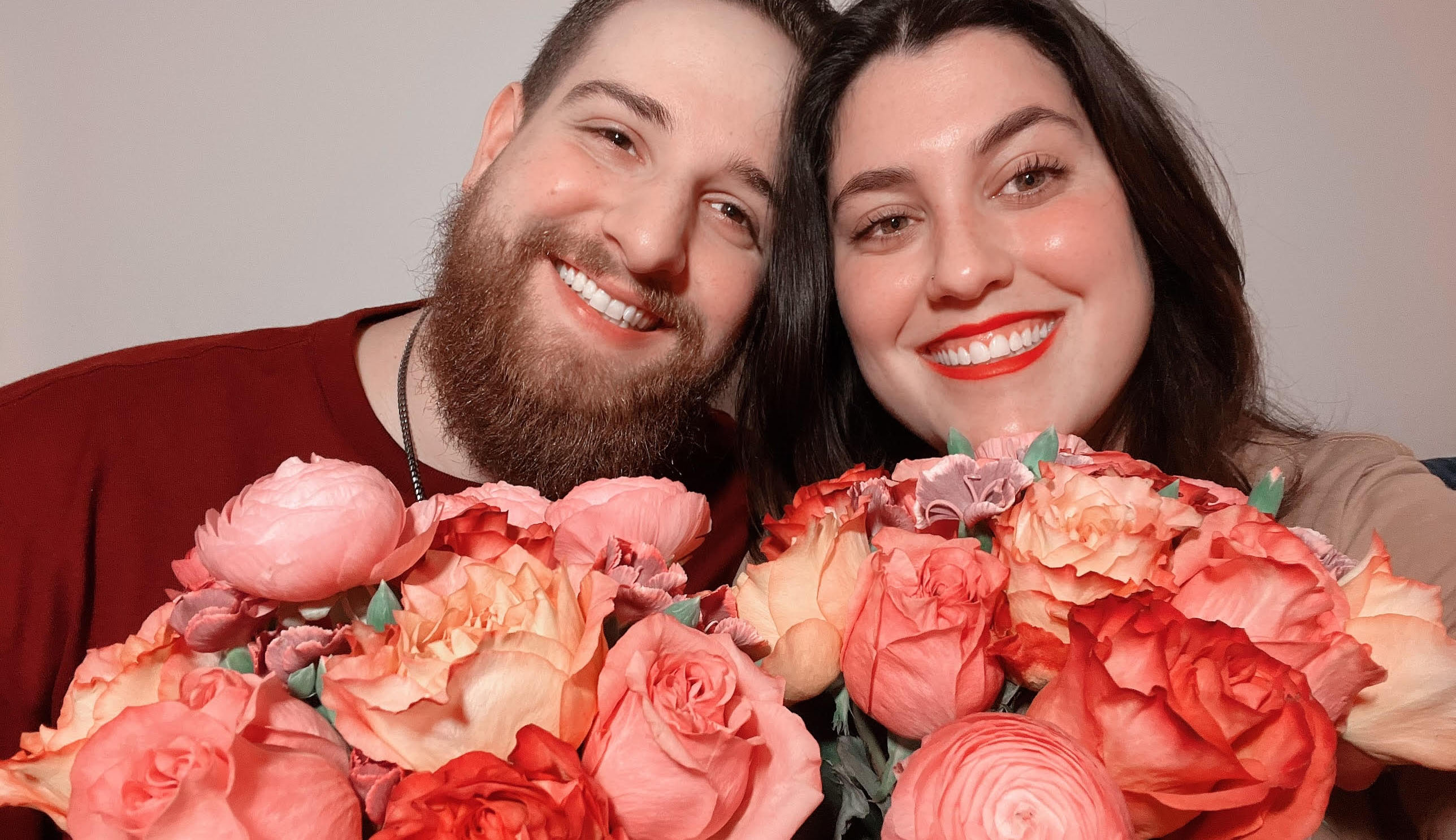 Couple holding pink and red romantic Valentine's Day Flowers