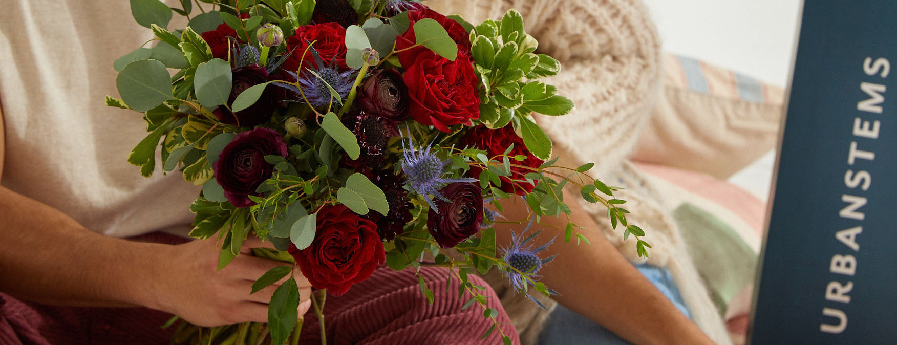 Close up of couple holding Valentine's Day flower bouquet
