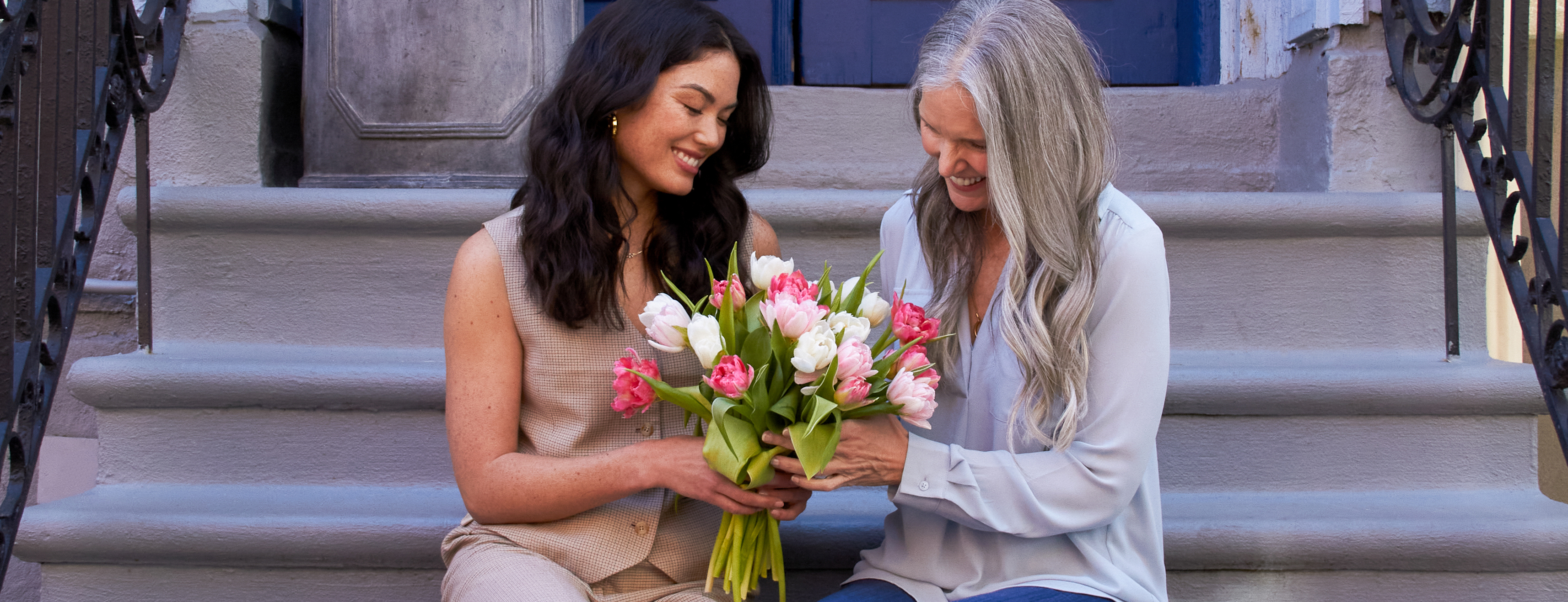 Woman gifting her mom Mother's Day flowers from UrbanStems.