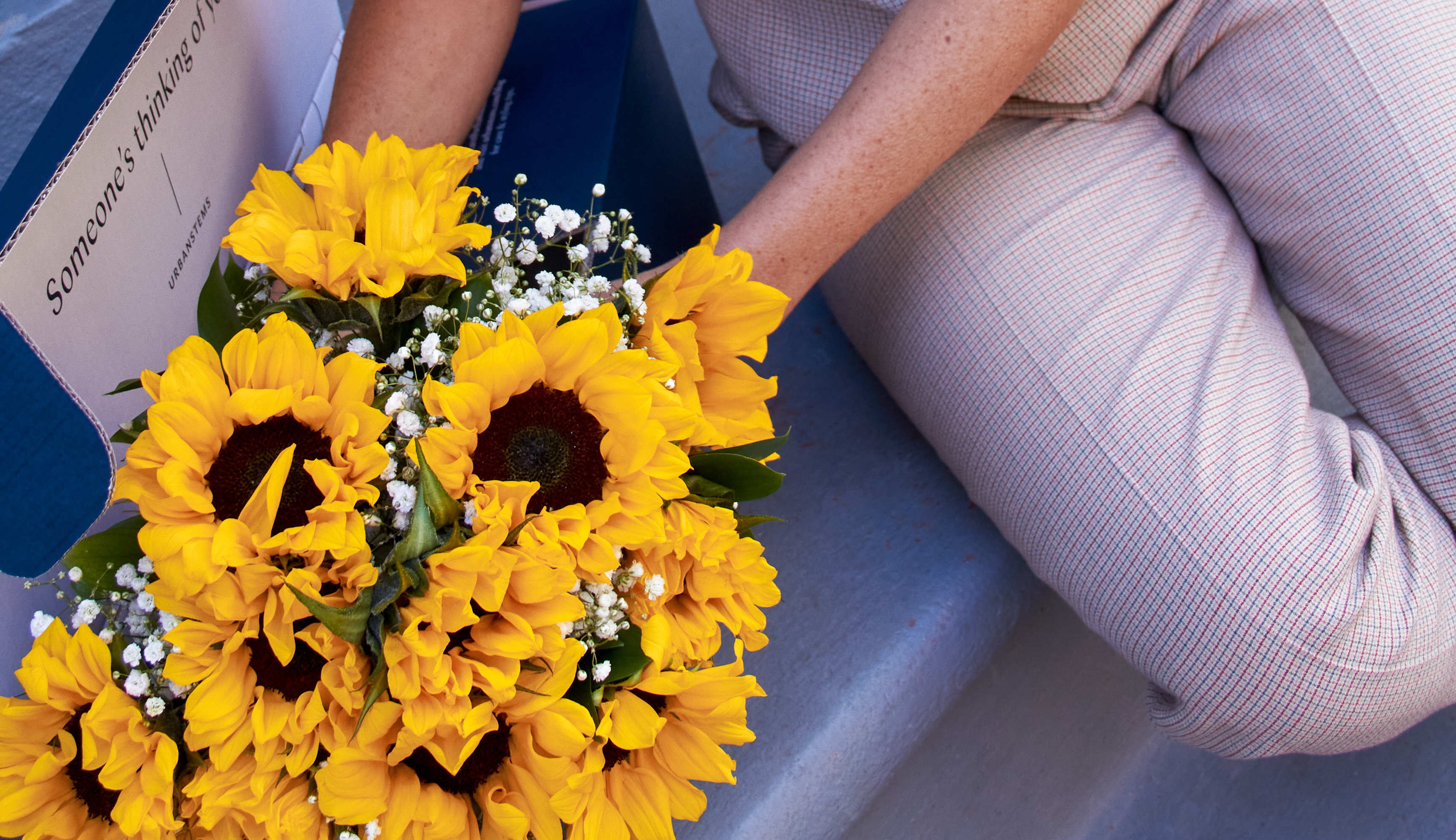 Woman with sunflower bouquet for next-day delivery