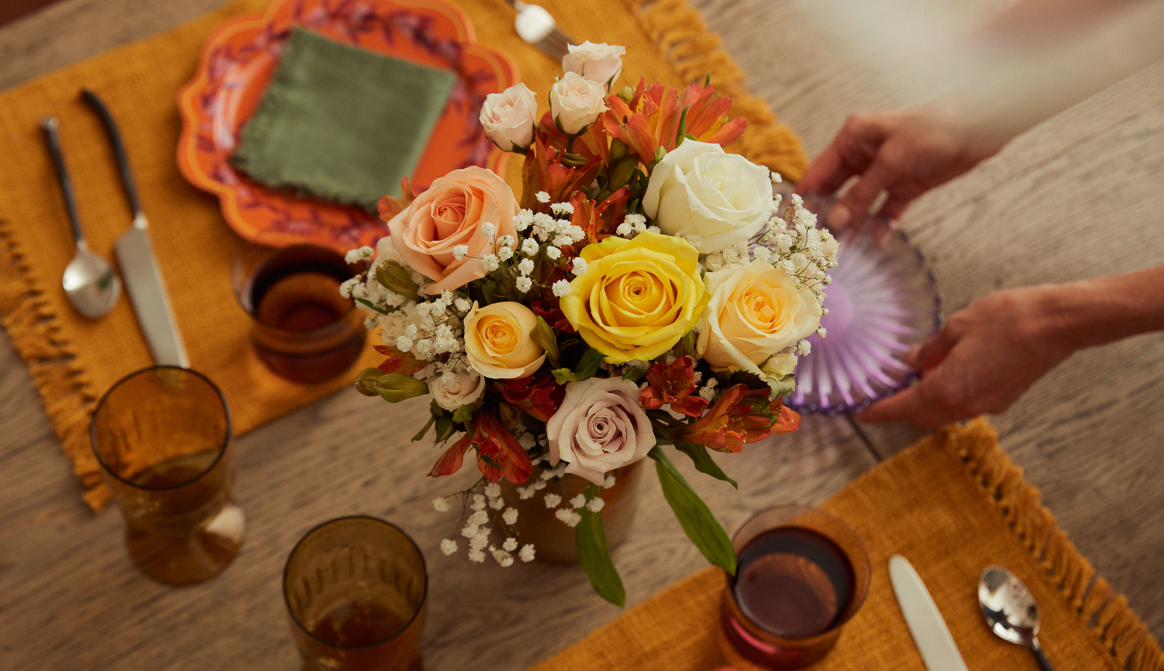 A table set for Thanksgiving 2022 with a floral centerpiece