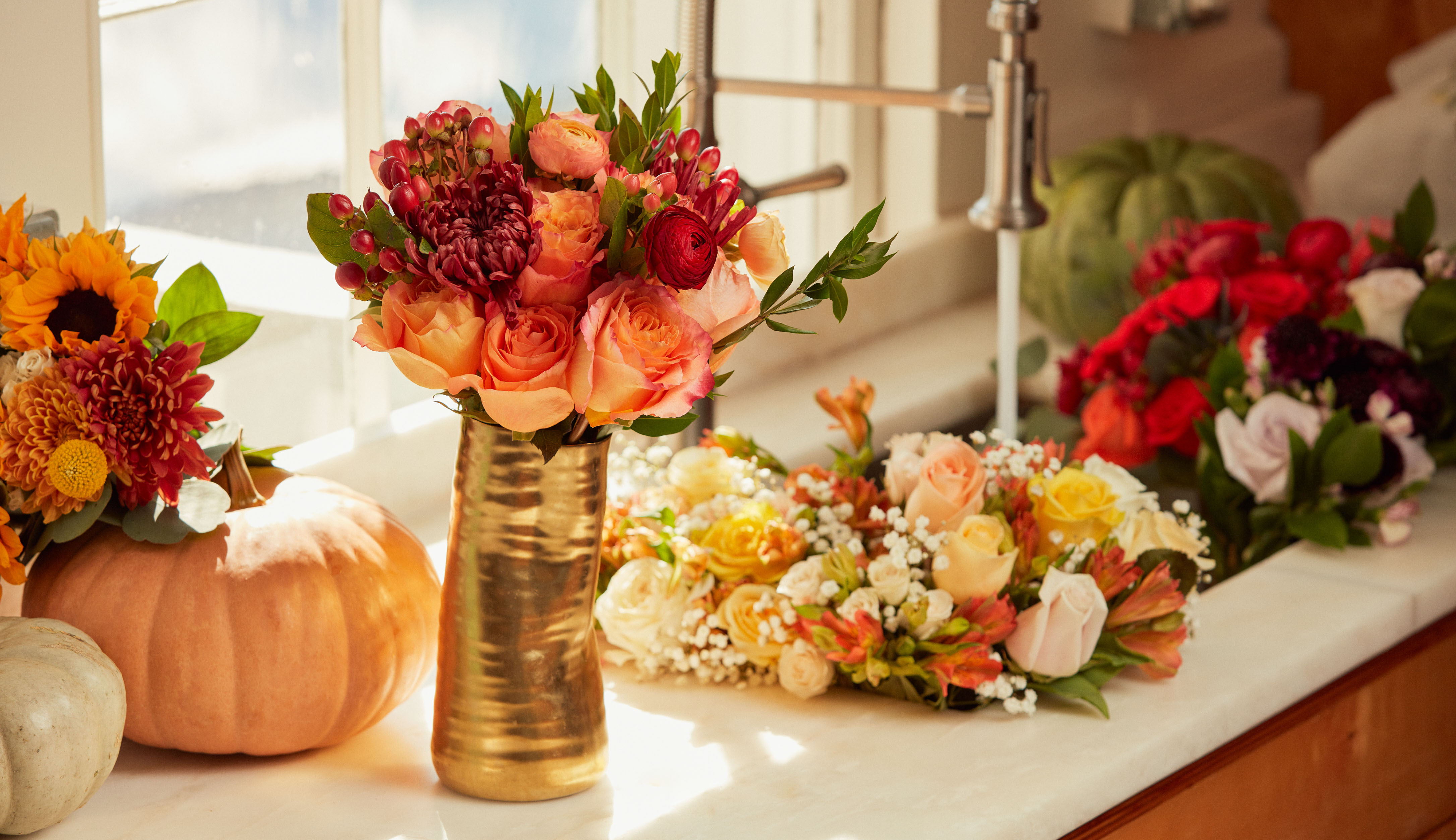 A table set for Thanksgiving 2022 with a floral centerpiece