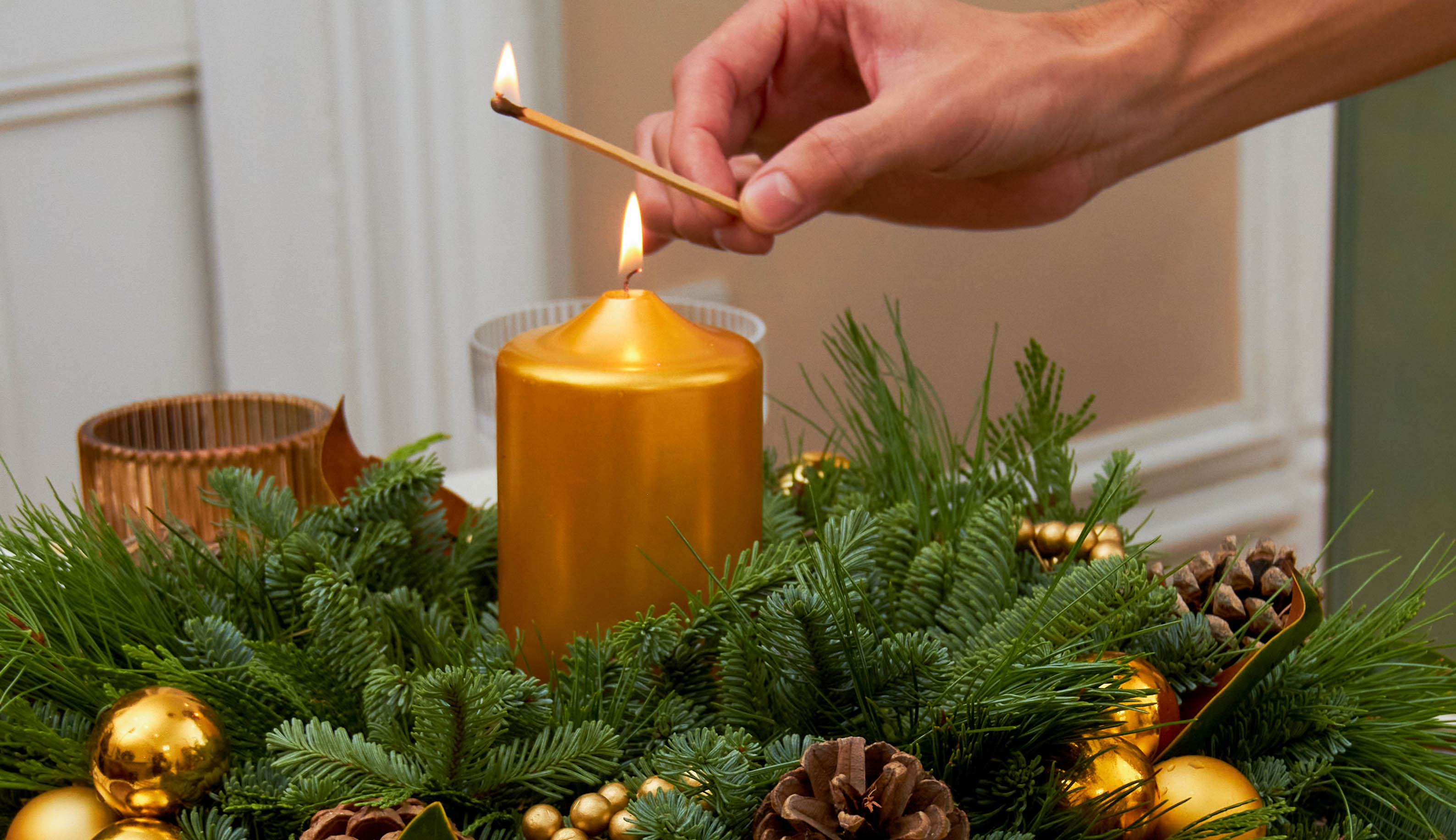 Hand lighting a candle for a table centerpiece