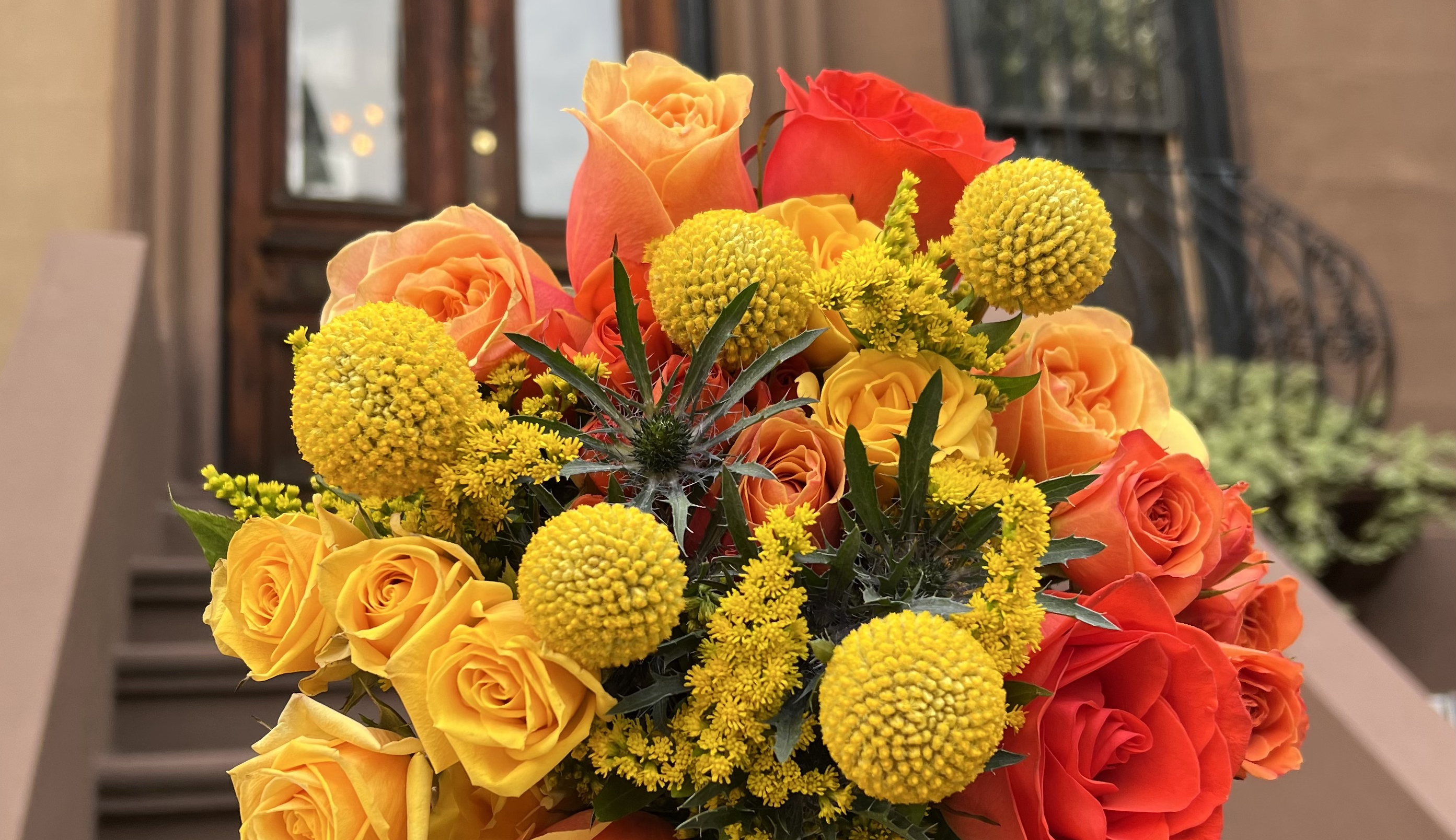 Close up of a bright orange floral bouquet for 2023