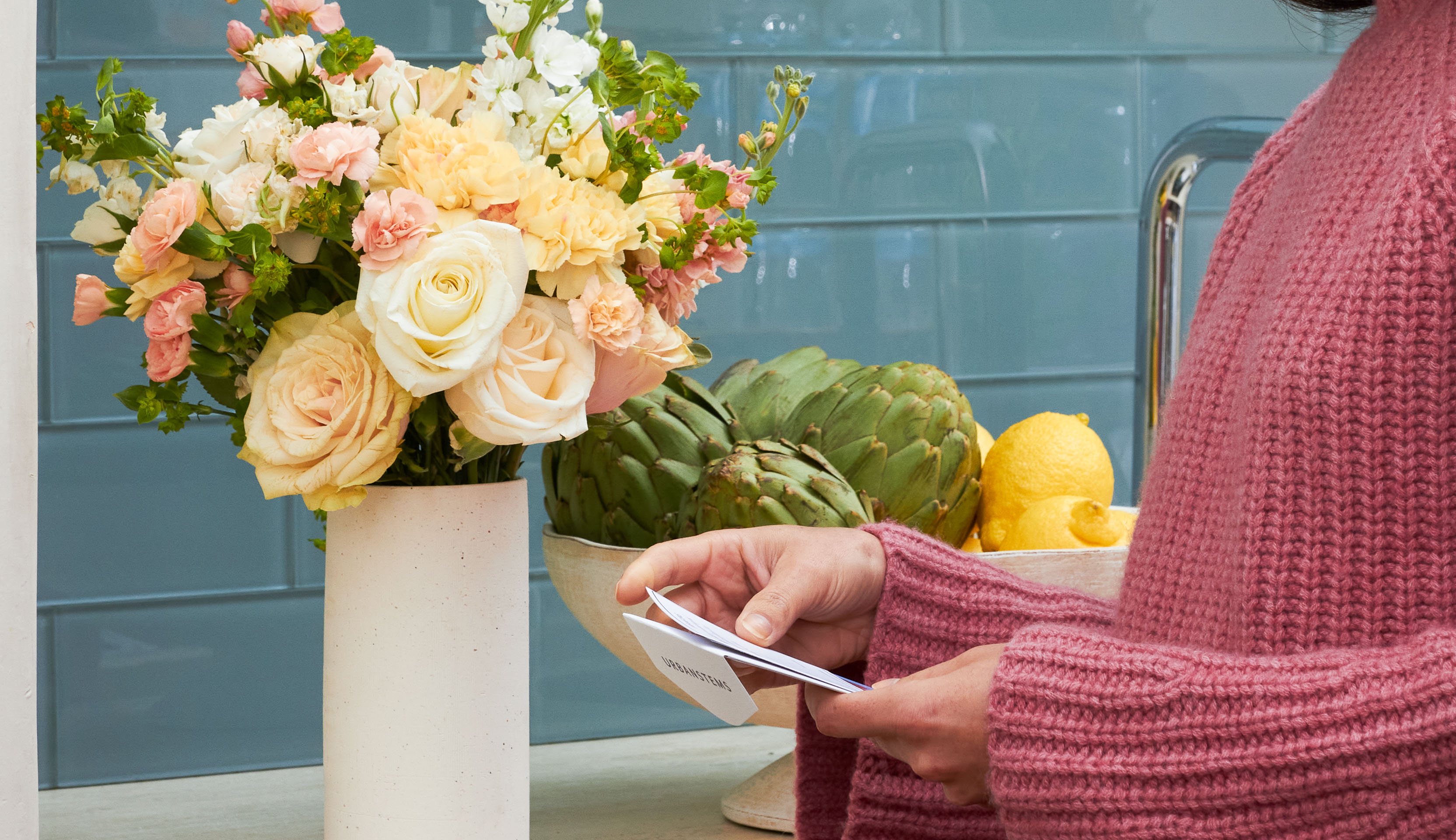 Woman reading ChatGPT generated note attached to her UrbanStems flower delivery