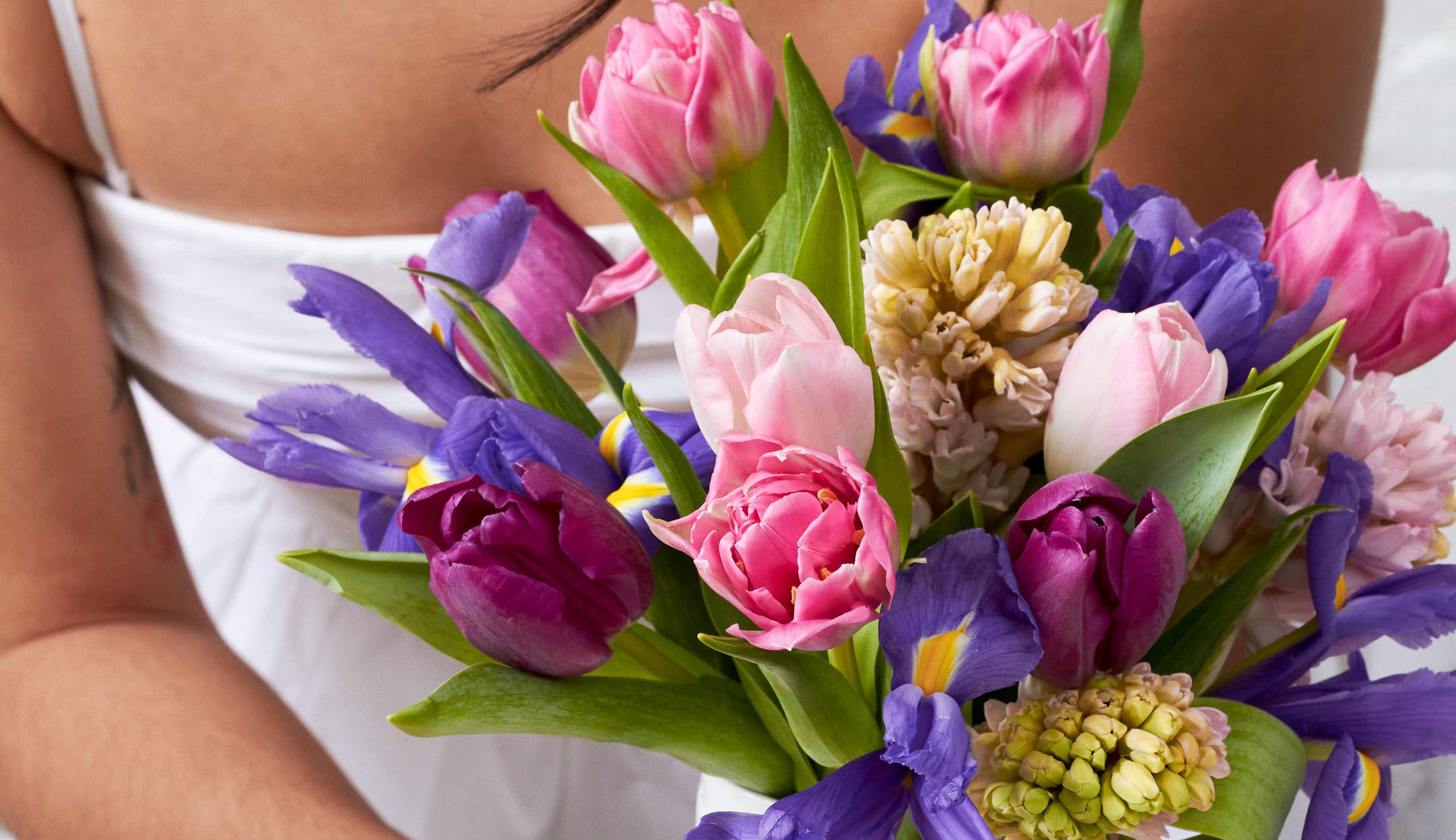 A bouquet of springtime flowers in shades of pink and purple